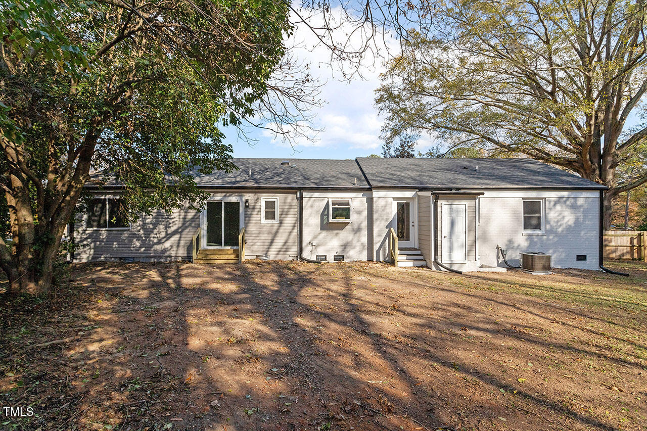 1014 Southerlund Road Garner, NC 27529 - Photo 32 of 36 a front view of a house with a garden