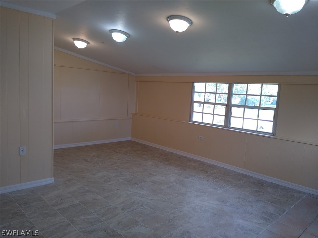 202 Oregon Road West Lehigh Acres, FL 33936 - Photo 3 of 26 an empty room with windows and closet