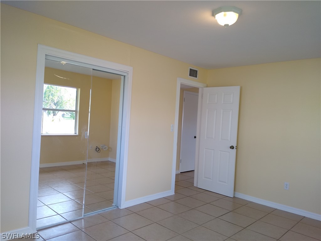 202 Oregon Road West Lehigh Acres, FL 33936 - Photo 8 of 26 a view of an empty room and window