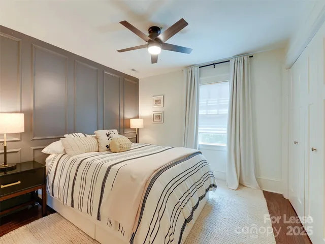 a bedroom with a large bed and a ceiling fan