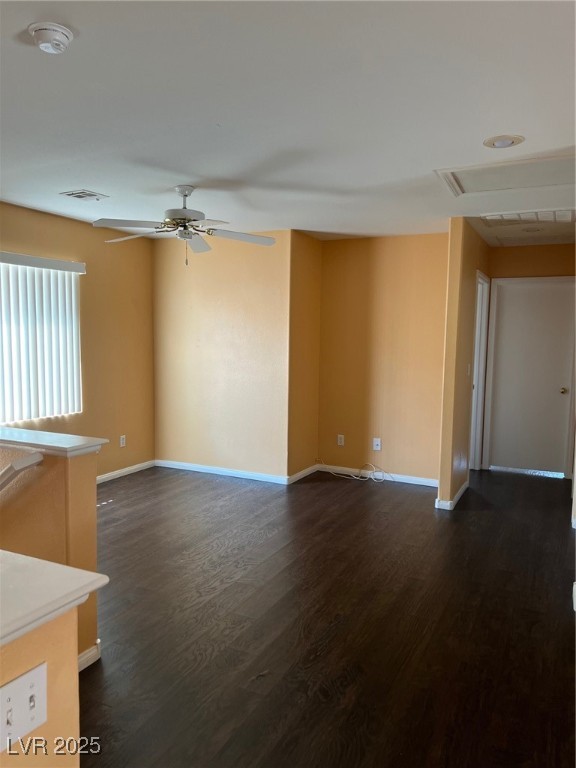 212 Silver Castle Street Las Vegas, NV 89144 - Photo 13 of 24 Unfurnished living room featuring visible vents, baseboards, dark wood-type flooring, and a ceiling fan