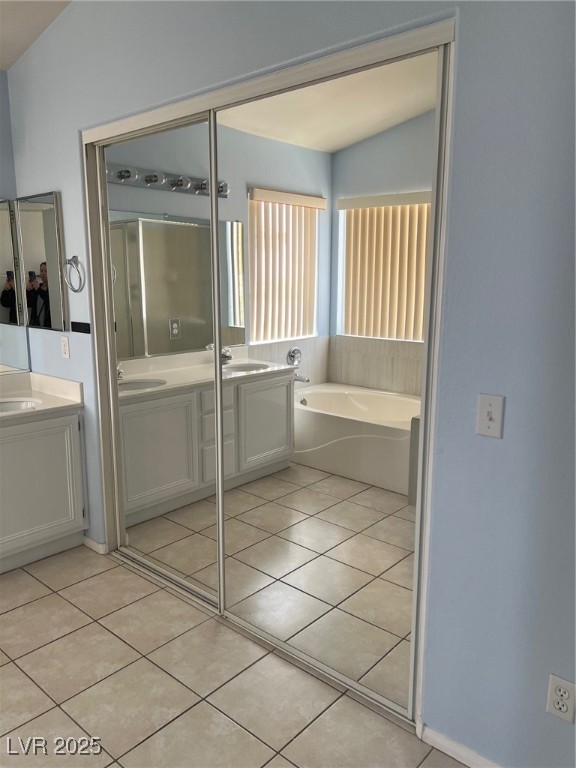 212 Silver Castle Street Las Vegas, NV 89144 - Photo 19 of 24 Full bath with tile patterned flooring, a sink, a bath, and double vanity