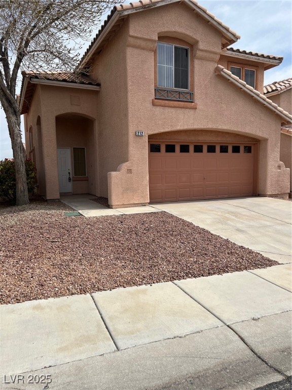212 Silver Castle Street Las Vegas, NV 89144 - Photo 2 of 24 View of front of house featuring stucco siding, concrete driveway, a tile roof, and a garage