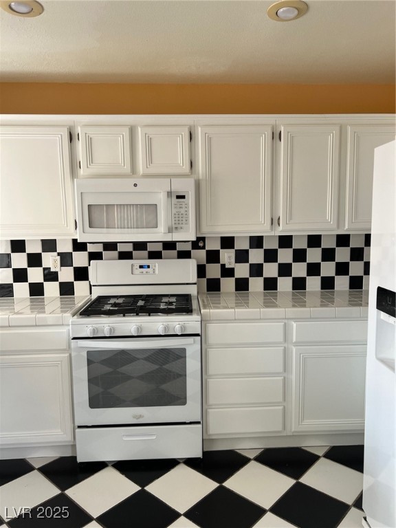 212 Silver Castle Street Las Vegas, NV 89144 - Photo 8 of 24 Kitchen featuring tile counters, range, and tile patterned floors