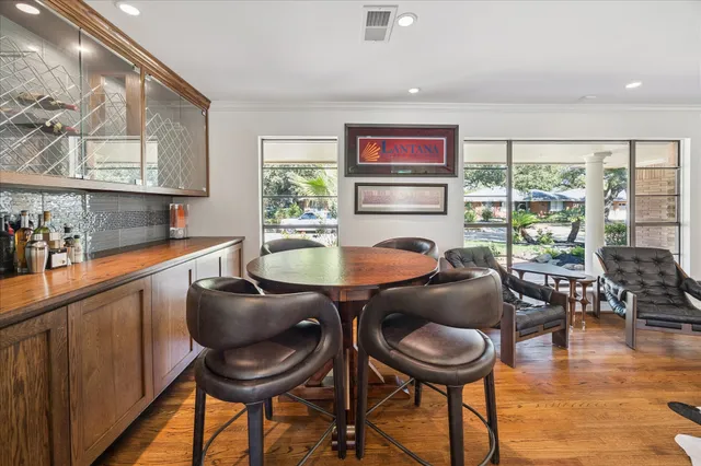 a dining room with furniture and a floor to ceiling window