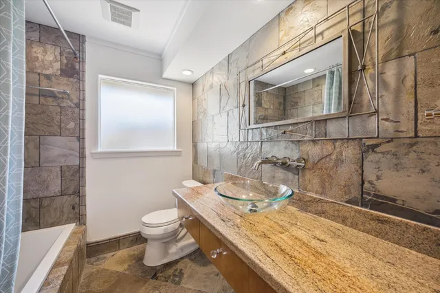 a view of a patio with table and chairs with wooden floor and fence