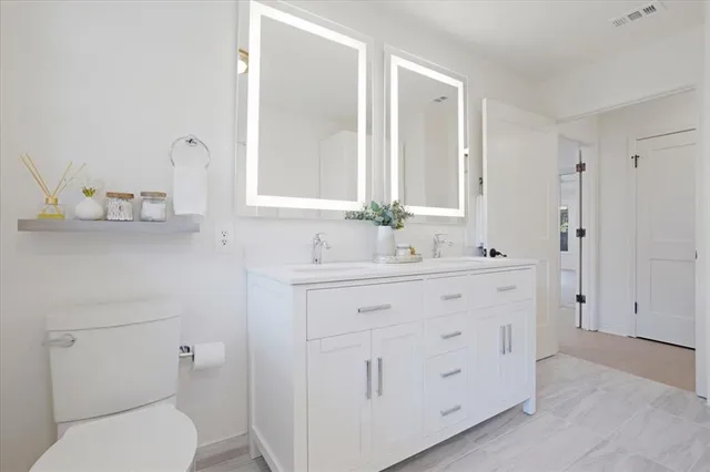 a kitchen with a table chairs refrigerator and microwave