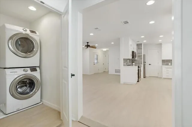 a bathroom with double vanity sink a toilet and a mirror