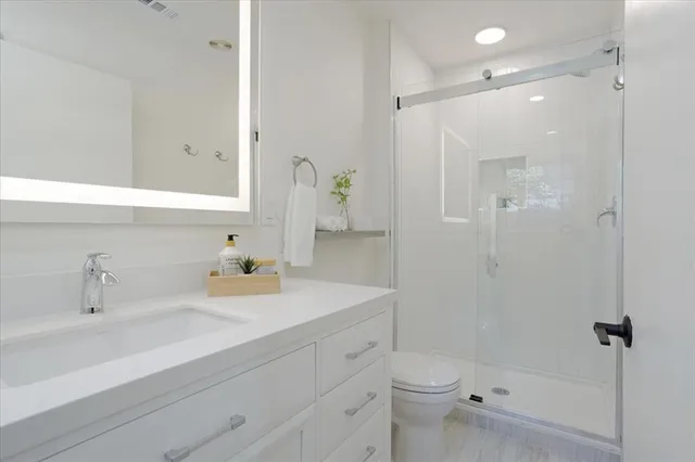 a view of a kitchen with a sink a washer and dryer