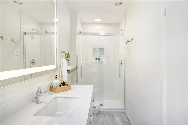a view of a hallway with a chandelier fan and windows
