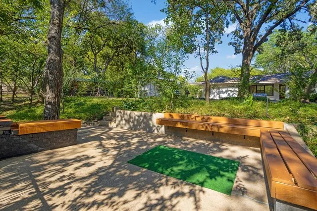 a view of a patio with table and chairs with wooden fence and floor