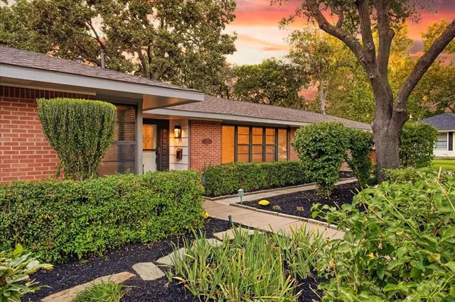 a front view of a house with garden