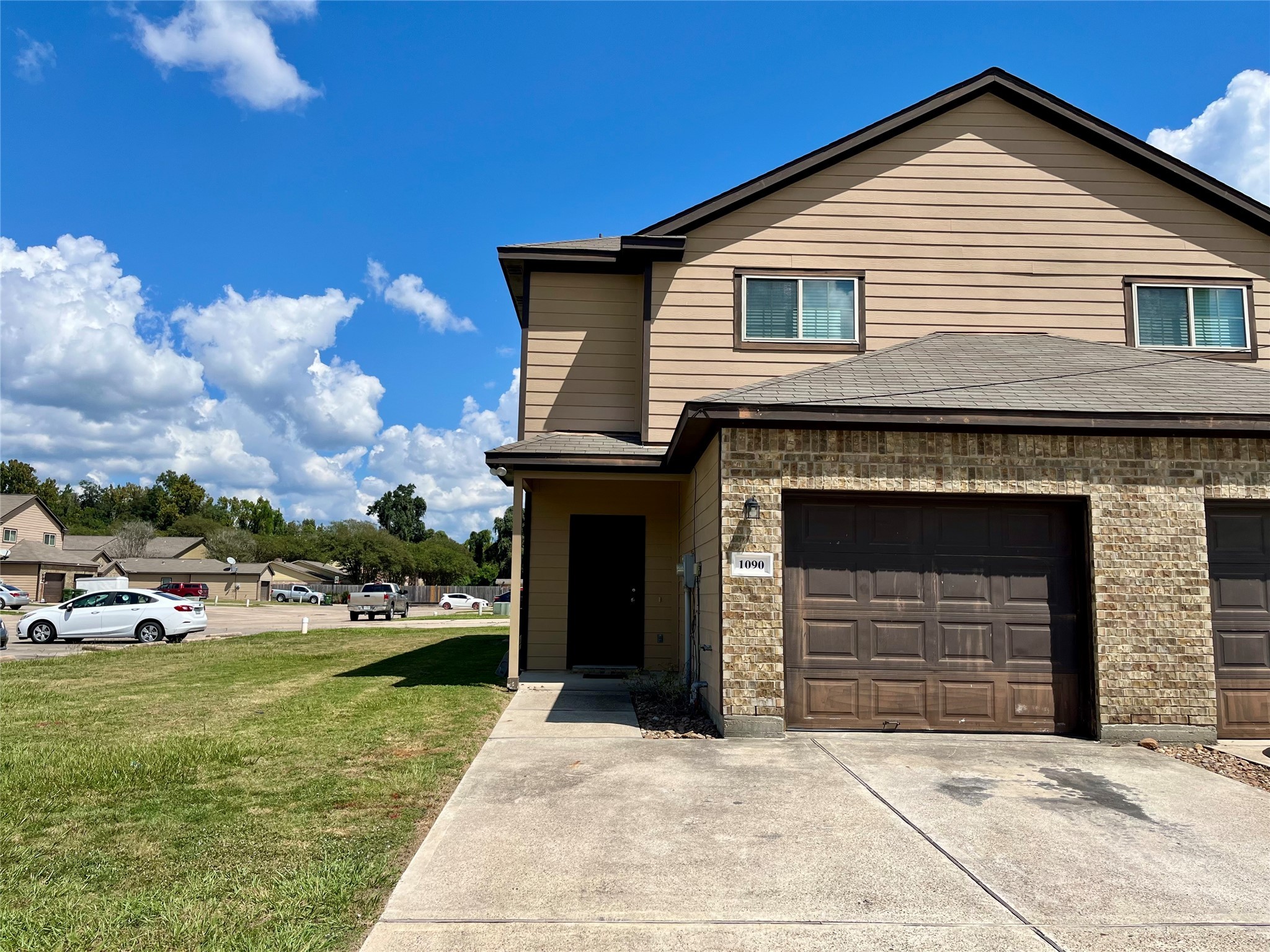 1090 North Colbert Street Dayton, TX 77535 - Photo 1 of 6 a front view of a house with a garden and yard