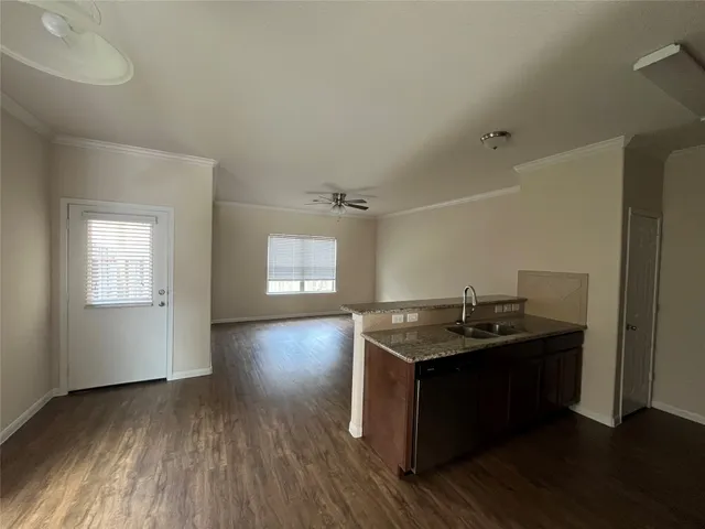 a utility room with cabinets and wooden floor