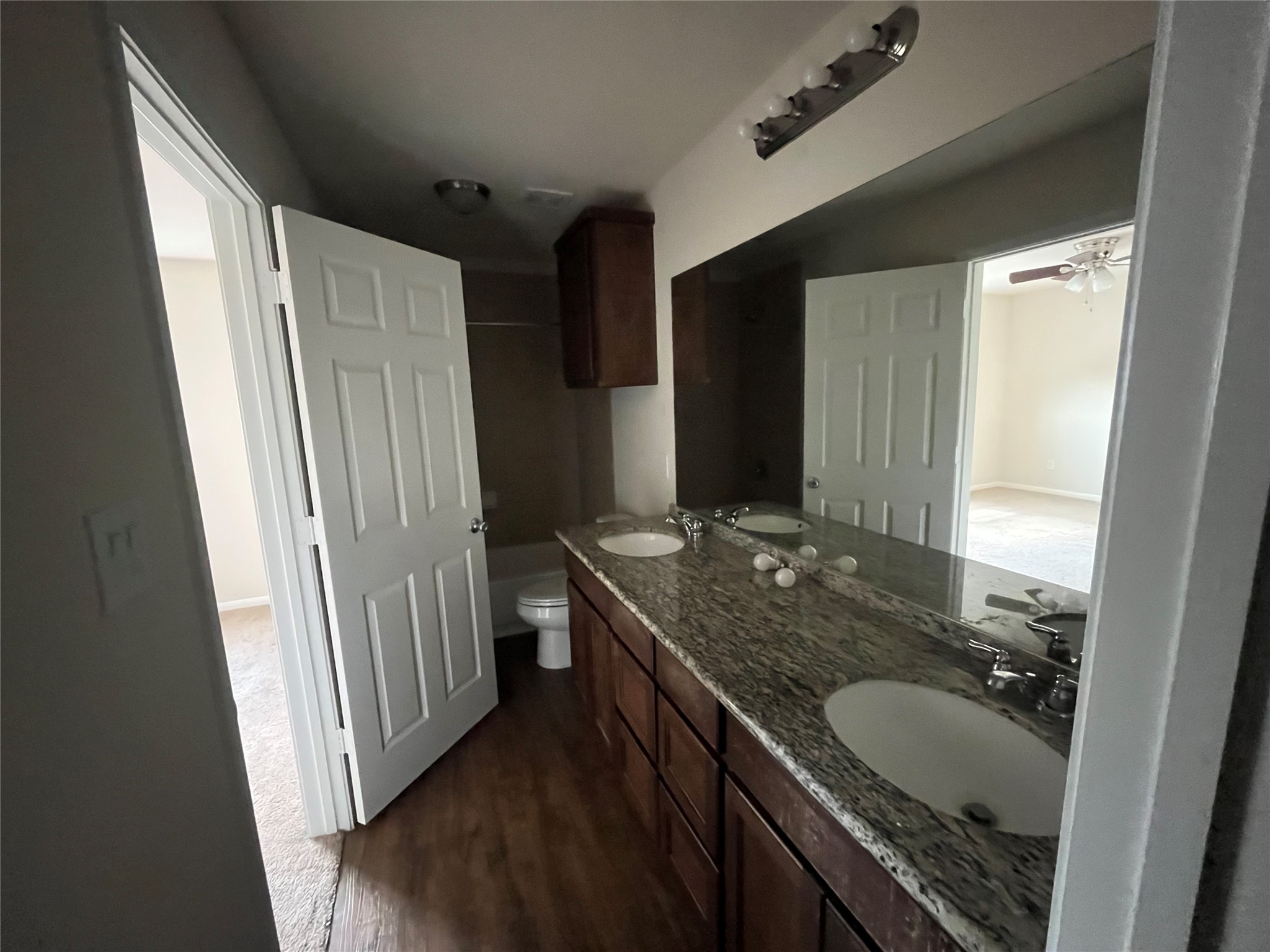 1090 North Colbert Street Dayton, TX 77535 - Photo 6 of 6 a bathroom with a granite countertop sink and a mirror