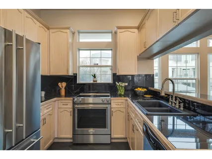a kitchen with a sink stove and refrigerator