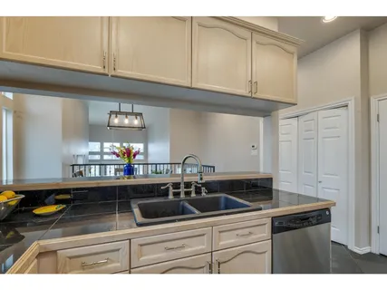 a kitchen with stainless steel appliances granite countertop a sink and cabinets