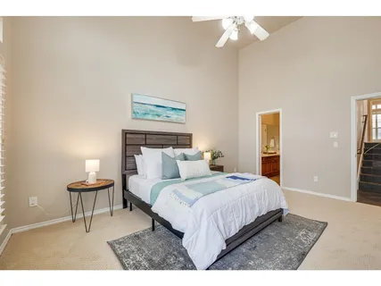 a bedroom with a bed and a chandelier