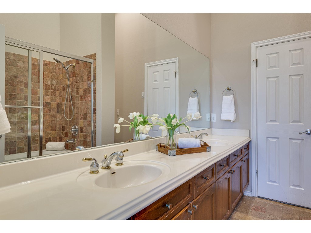 2918 Ranch Road 620 North, Unit U254 Austin, TX 78734 - Photo 16 of 35 a bathroom with a granite countertop sink and a mirror