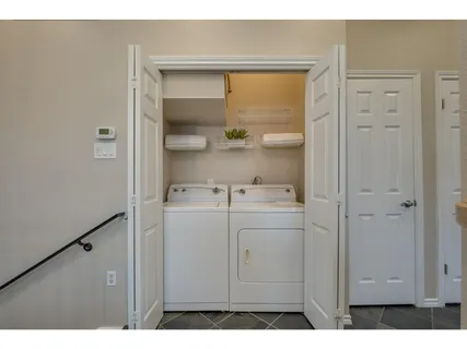 a utility room with closet dryer and washer