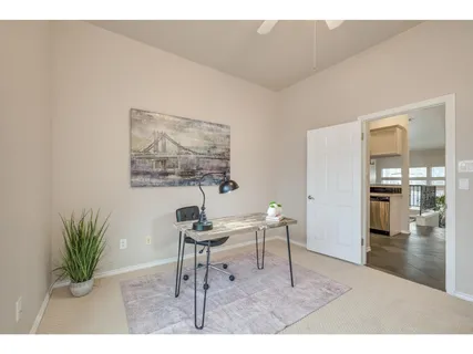a living room with furniture and a painting on the wall