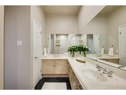 a bathroom with a sink a large mirror and a bathtub