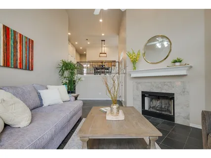a living room with furniture a mirror and a fireplace