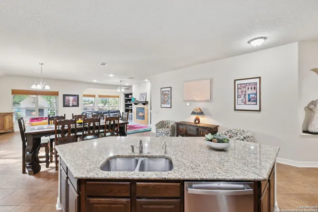 a kitchen with a counter space a sink and cabinets