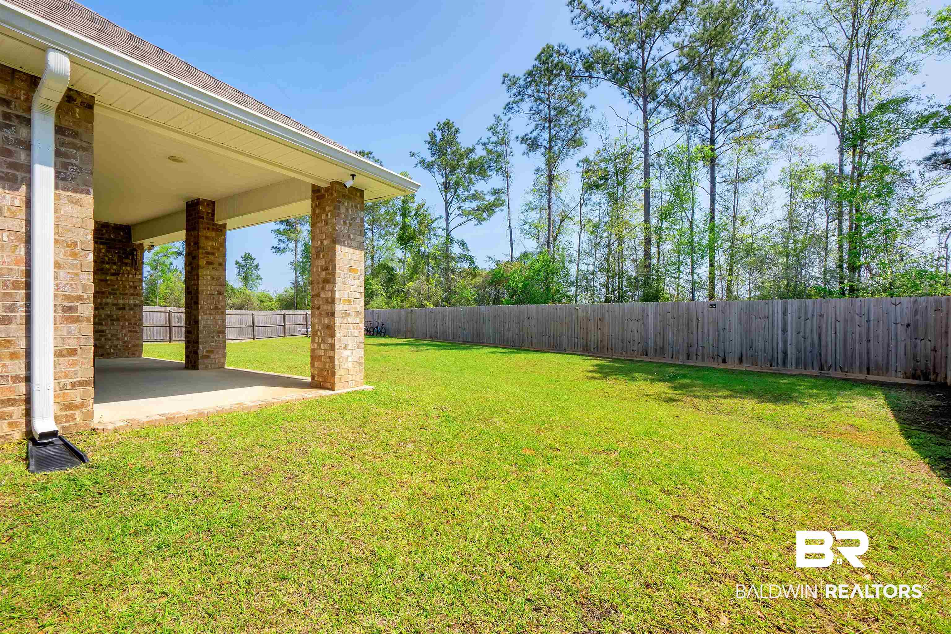 31671 Memphis Loop Daphne, AL 36527 - Photo 32 of 51 View of yard featuring a fenced backyard and a patio area