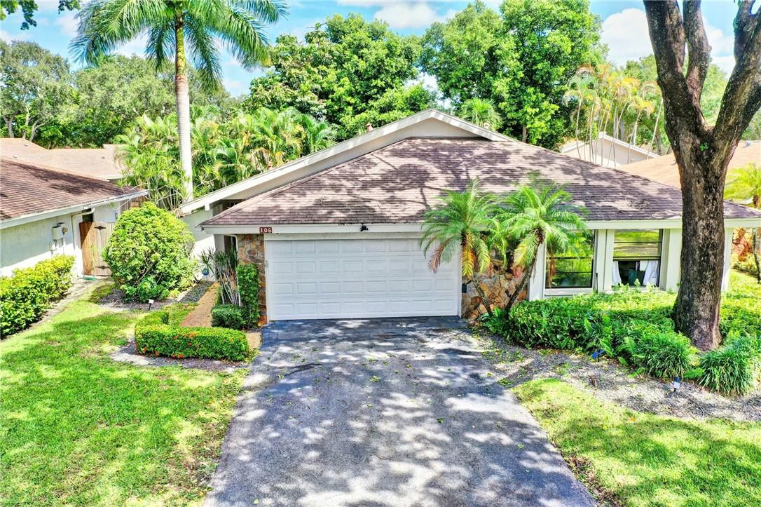 106 Kensington Road Hollywood, FL 33021 - Photo 1 of 42 a front view of a house with garden