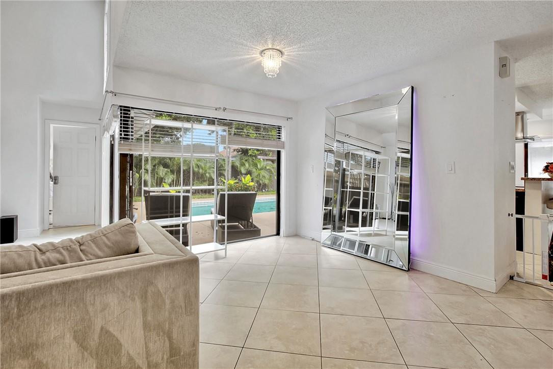 106 Kensington Road Hollywood, FL 33021 - Photo 13 of 42 a living room with furniture and large windows