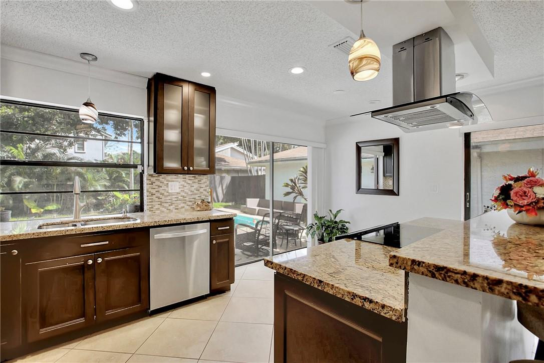 106 Kensington Road Hollywood, FL 33021 - Photo 17 of 42 a kitchen with stainless steel appliances granite countertop a sink and a stove
