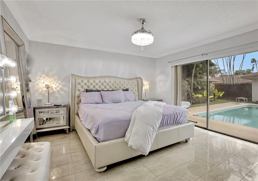 106 Kensington Road Hollywood, FL 33021 - Photo 23 of 42 a bedroom with a bed and a large window