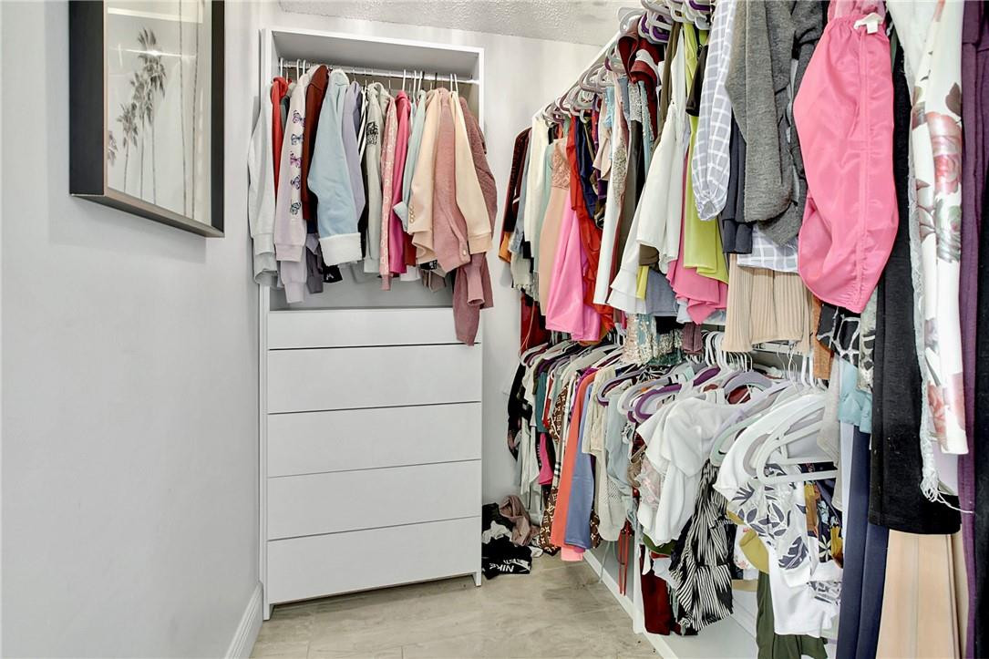106 Kensington Road Hollywood, FL 33021 - Photo 27 of 42 a view of walk in closet with clothes