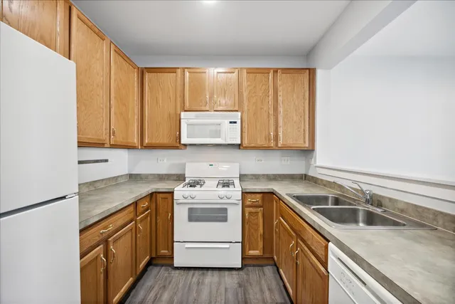 a kitchen with a sink stove top oven and cabinets