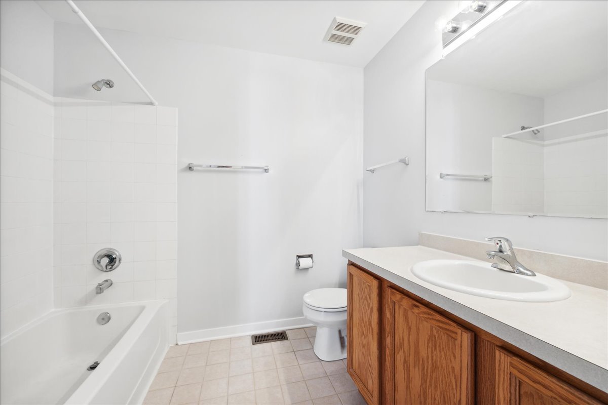 2435 Georgetown Circle Aurora, IL 60503 - Photo 8 of 10 a bathroom with a sink a toilet and shower