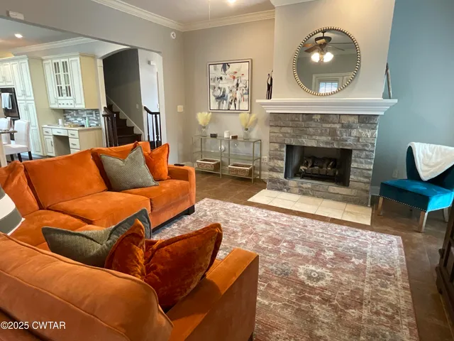 a living room with furniture and a fireplace