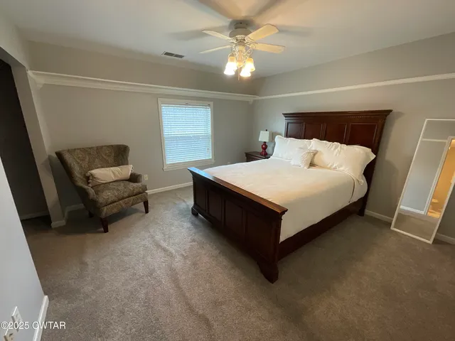 a view of a house with a tree and a yard