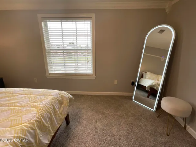 a bedroom with a bed and a night stand