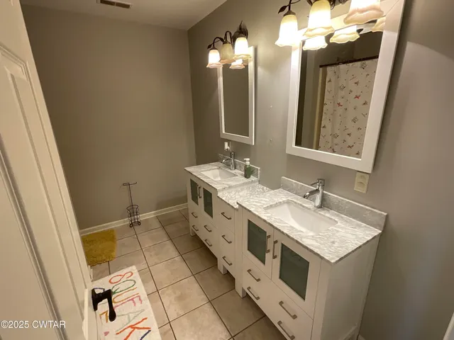 a bathroom with a toilet and a shower curtain