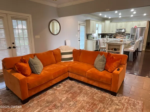 a living room with furniture kitchen and a window