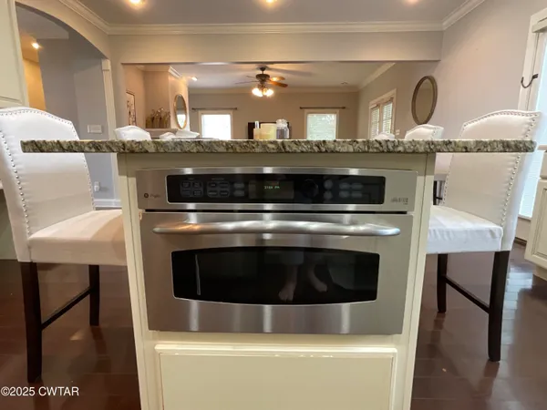 a stove top oven sitting inside of a kitchen