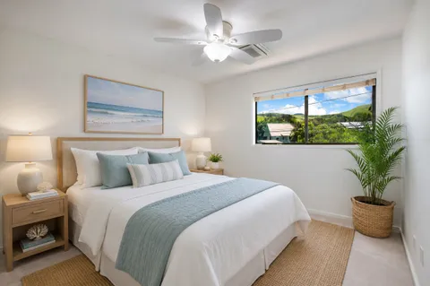 a bedroom with bed and a potted plant