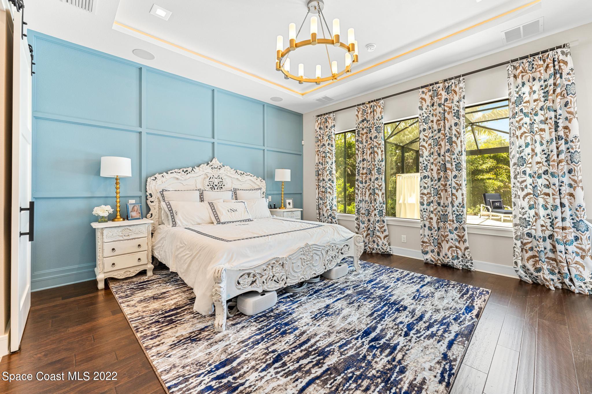 4574 Milost Drive Rockledge, FL 32955 - Photo 13 of 41 a spacious bedroom with a bed and wooden floor