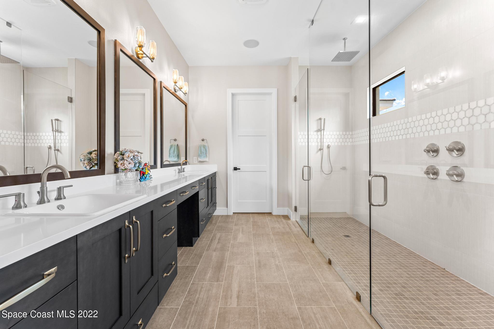 4574 Milost Drive Rockledge, FL 32955 - Photo 14 of 41 a bathroom with a double vanity sink mirror double and shower