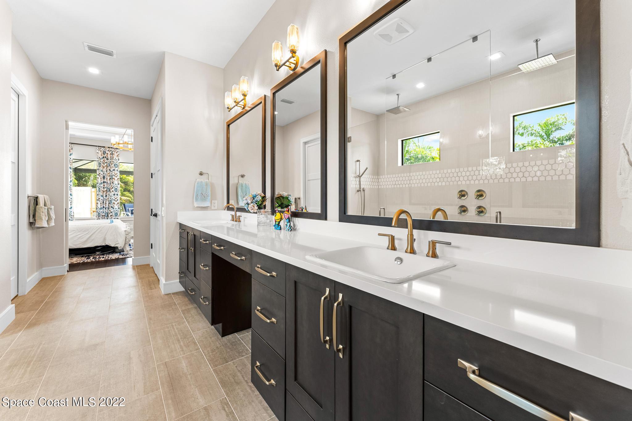 4574 Milost Drive Rockledge, FL 32955 - Photo 16 of 41 a large bathroom with a double vanity sink and a large mirror