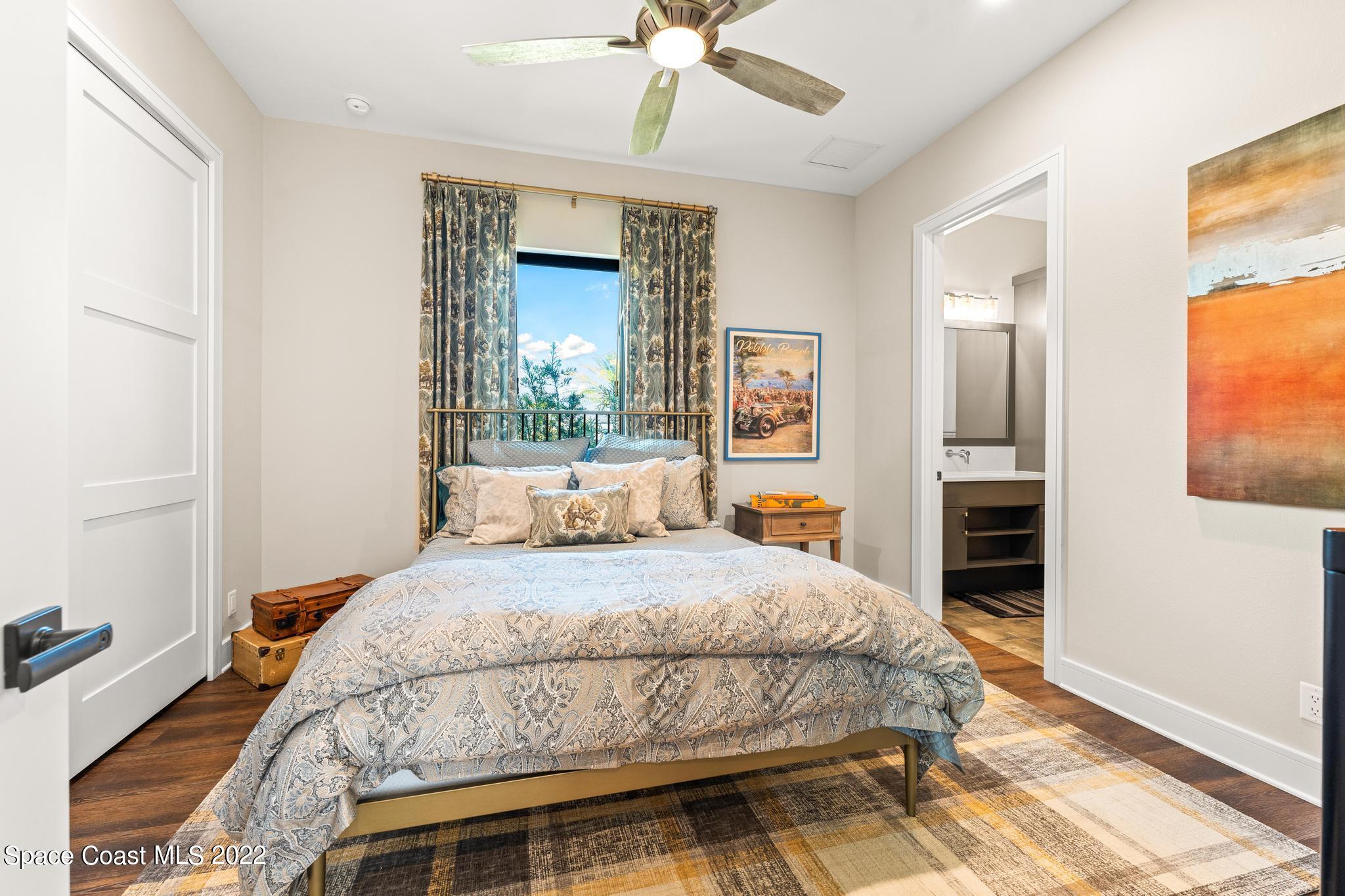 4574 Milost Drive Rockledge, FL 32955 - Photo 25 of 41 a bedroom with a bed and a chandelier