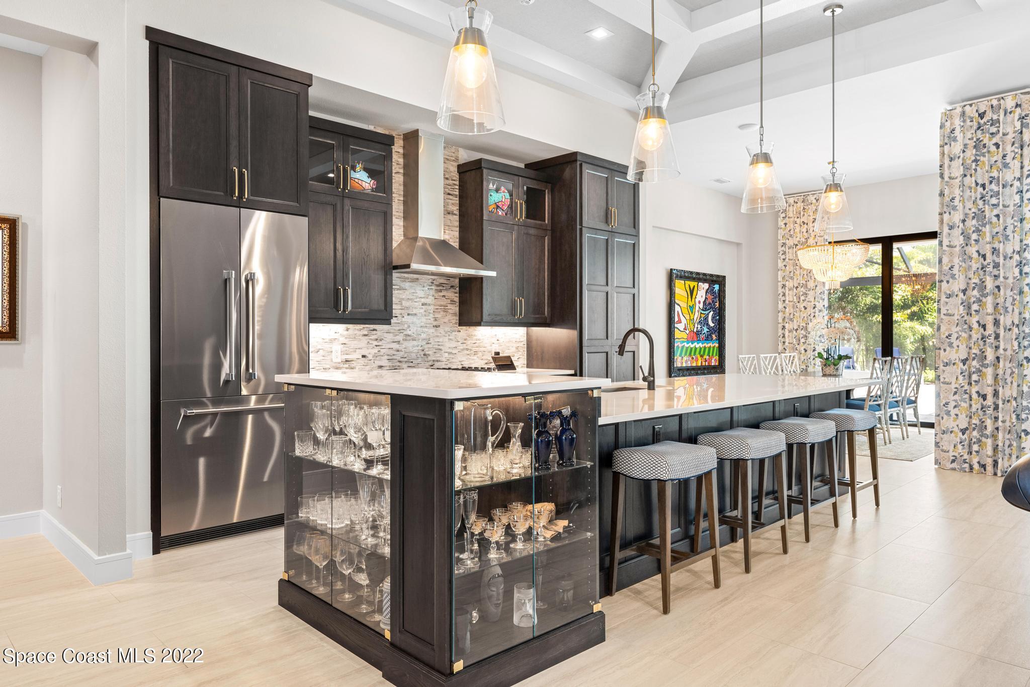 4574 Milost Drive Rockledge, FL 32955 - Photo 6 of 41 a kitchen with stainless steel appliances kitchen island granite countertop a table chairs and a refrigerator