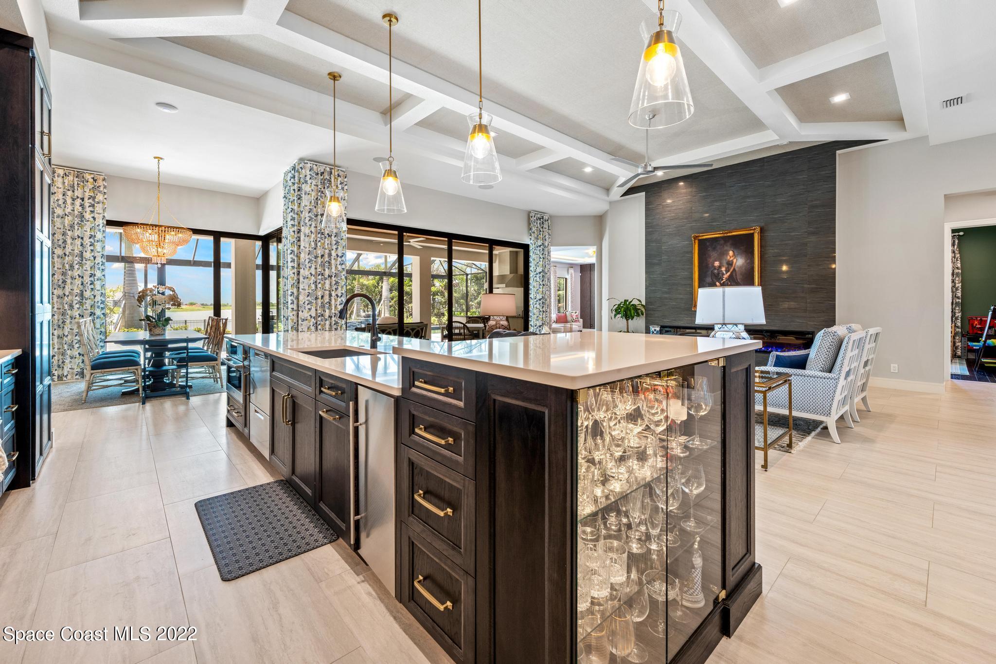 4574 Milost Drive Rockledge, FL 32955 - Photo 7 of 41 a kitchen with stainless steel appliances kitchen island granite countertop a sink and cabinets