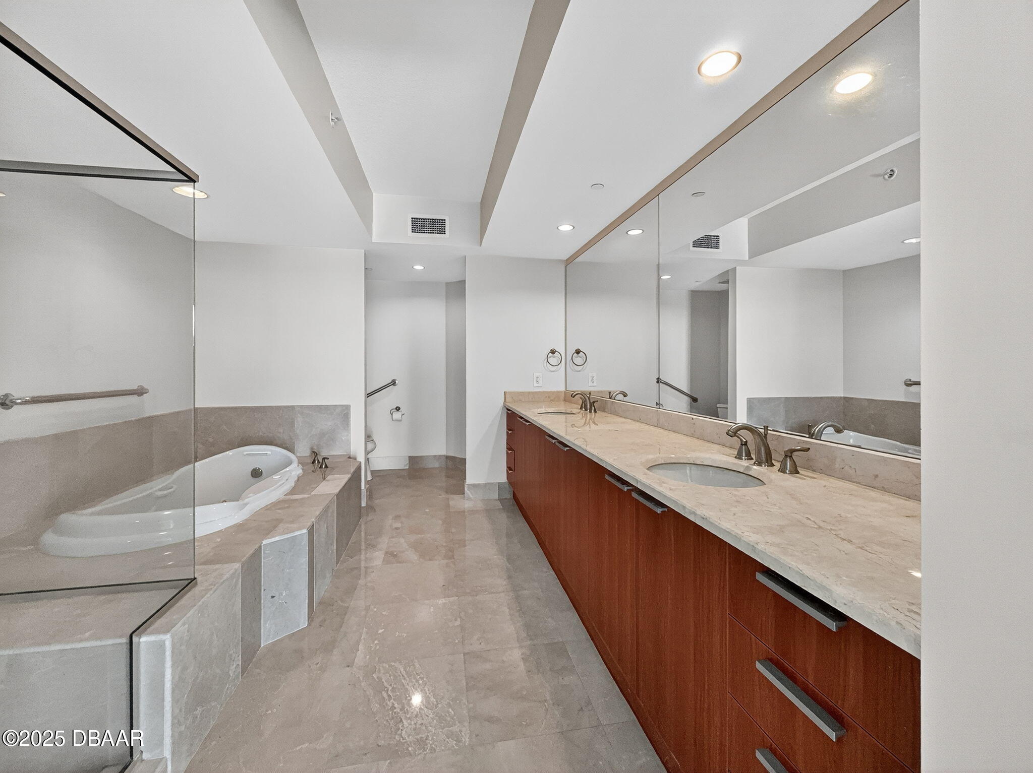 231 Riverside Drive, Unit 903 Holly Hill, FL 32117 - Photo 13 of 28 a large bathroom with a large tub sink and vanity